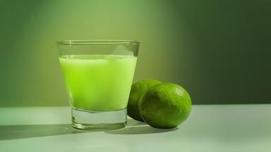 Grüner Cocktail und daneben eine Limette