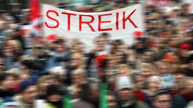 Symbolbild Streik - Transparent mit Aufschrift "Wie streiken"
