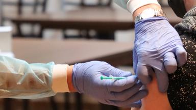 Junger Mann erhält ein Impfung in den Oberarm