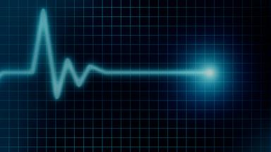 Eine türkise EKG-Linie auf schwarzem Hintergrund