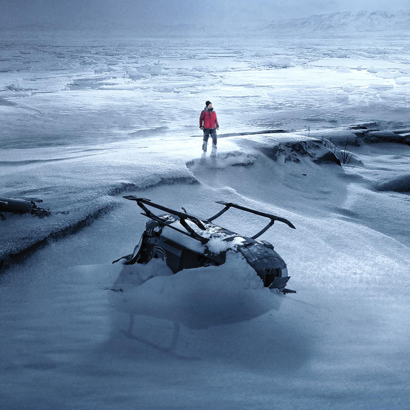 Arctic: In einer weiten, verschneiten Eislandschaft steht eine einzelne Person in roter Jacke zwischen den Wrackteilen eines Flugzeugs und eines Hubschraubers.