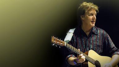 Porträt von Paul McCartney mit Gitarre.
