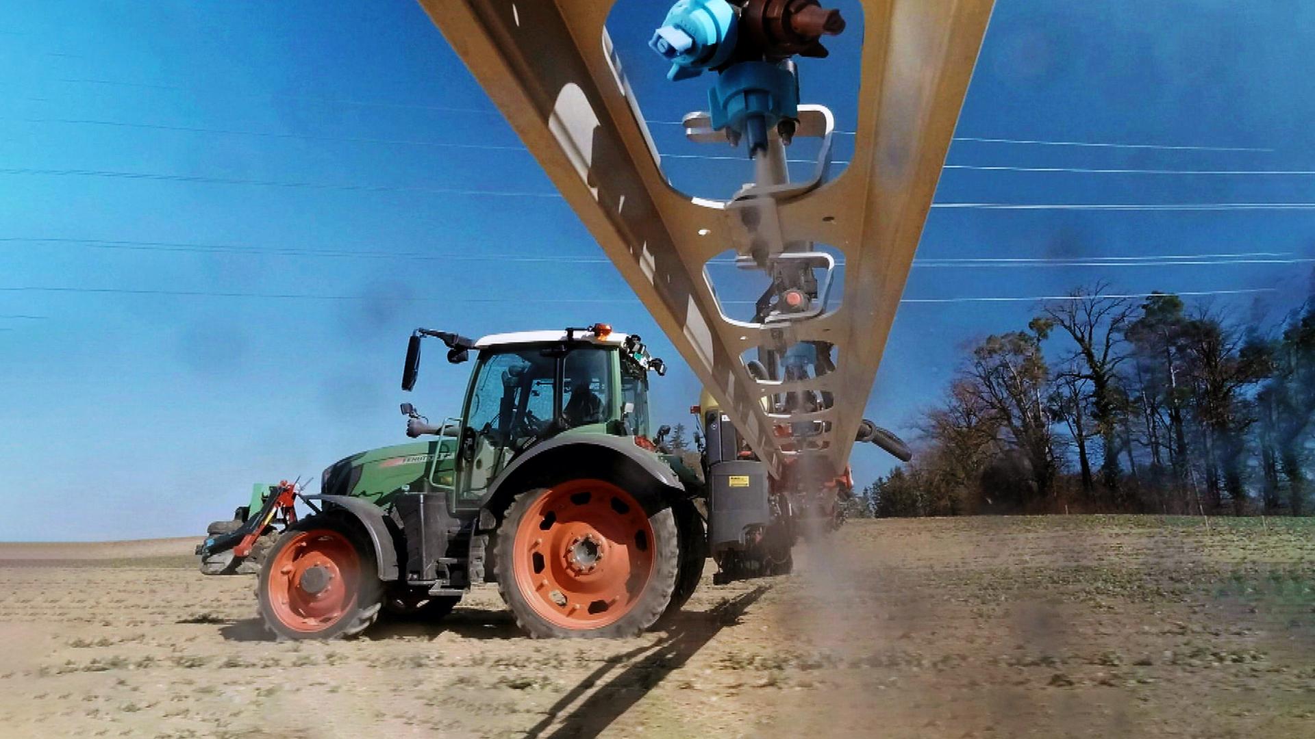 Ein Traktor sprüht Pestizide auf einen Acker