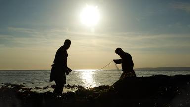 Reenactors Wikinger bereiten ihr Fischernetz vor. 
