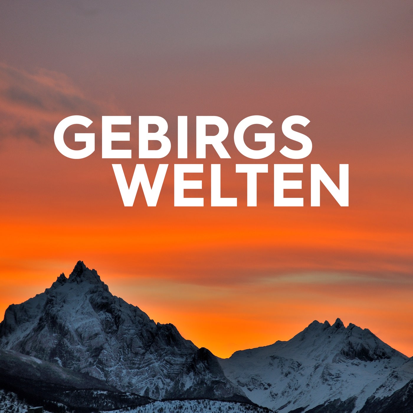 die Silhouette einer Gebirgskette vor orangenem Himmel