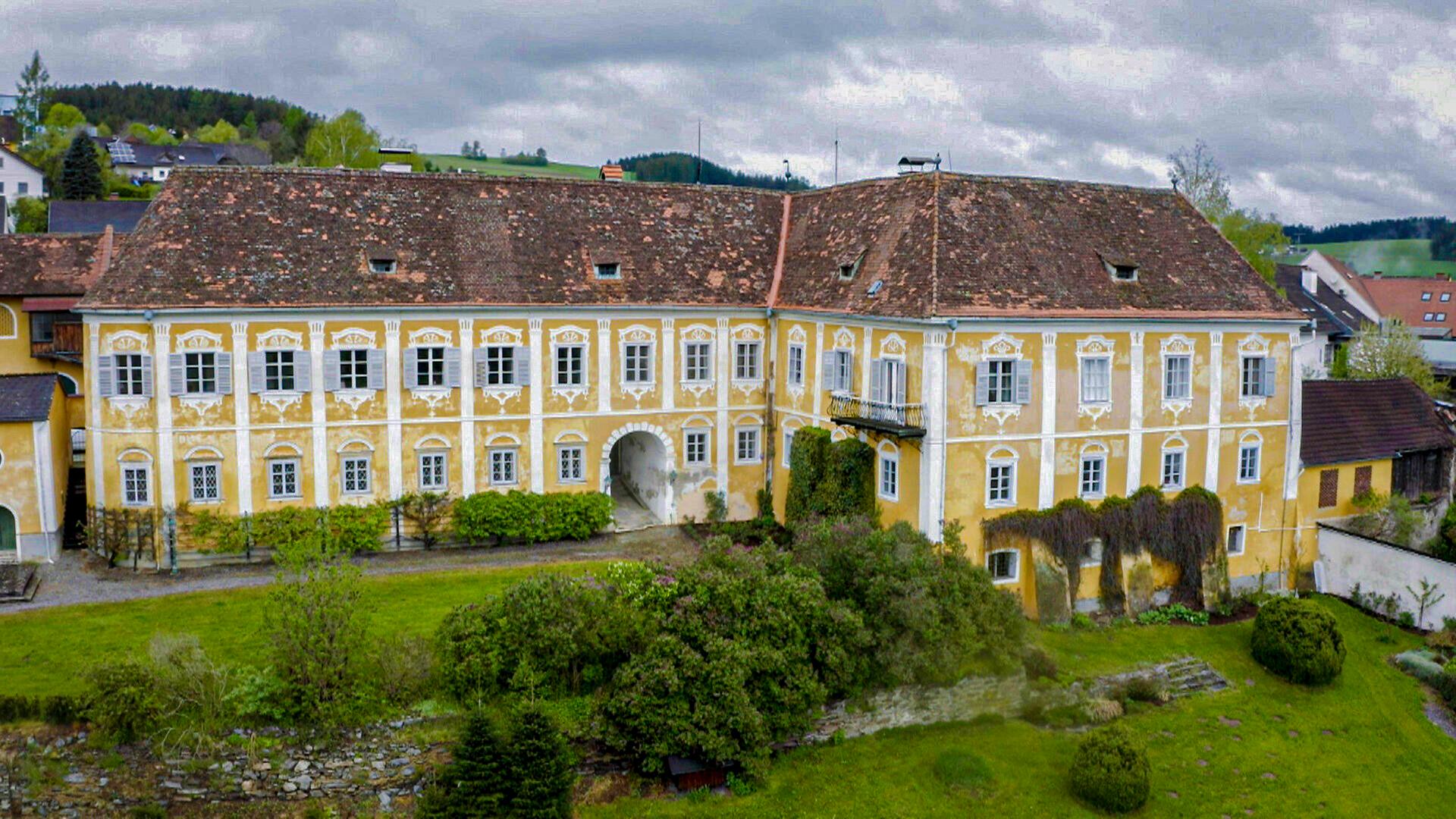 Leicht verwitterter, verzierter Gebäudekomplex mit großem Gartengelände
