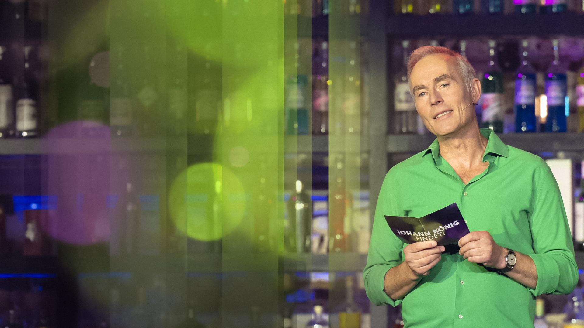 Johann König im grünen Hemd beim Moderieren.