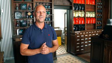 Malte Kromm hinter der Theke einer alten Apotheke