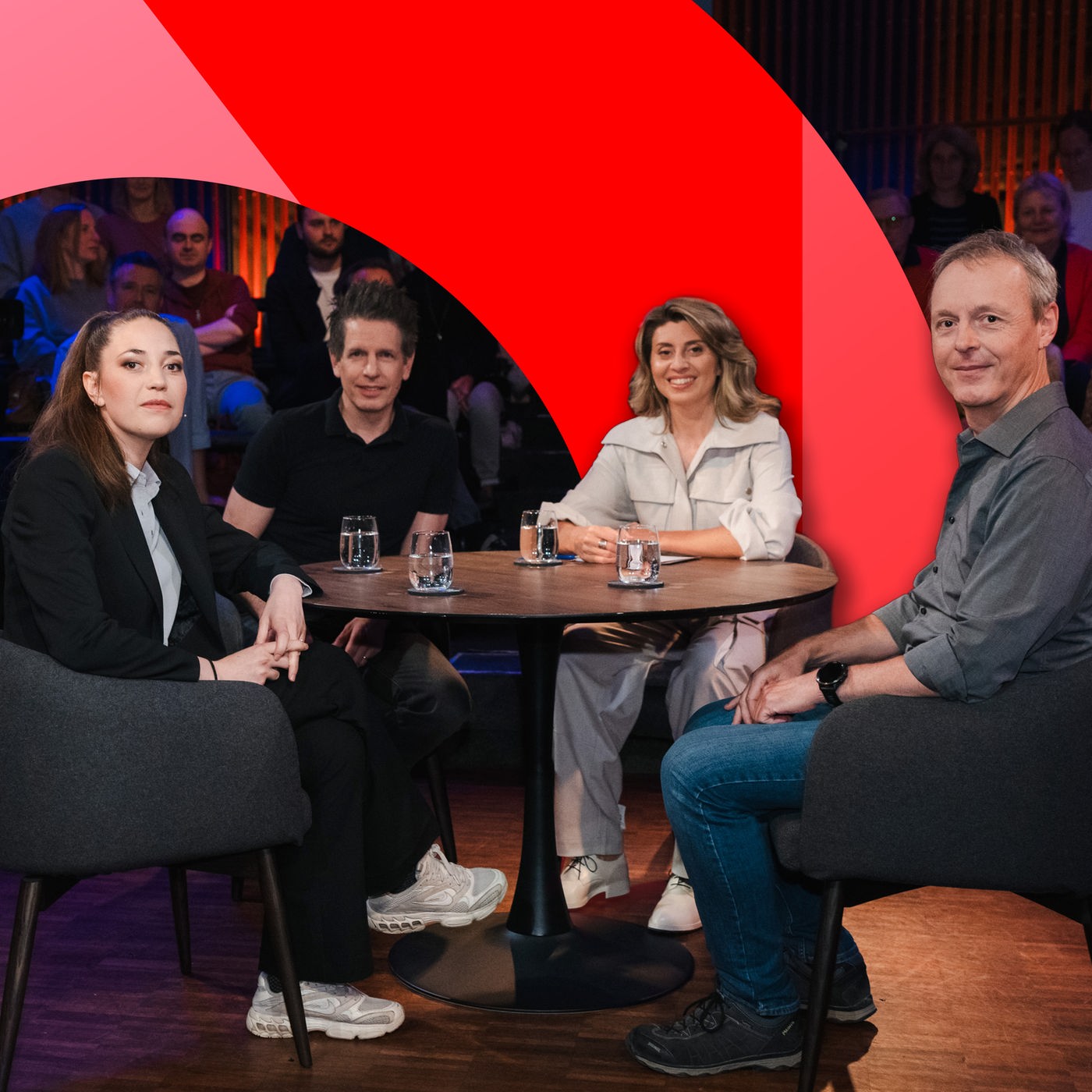 Vier Personen sitzen in ein einer Gesprächsrunde
