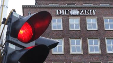 Rote Ampel steht vor Gebäude mit Aufschrift "Die Zeit"