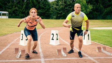 Eine Frau und ein Mann beim Startschuss auf einer Tartanbahn