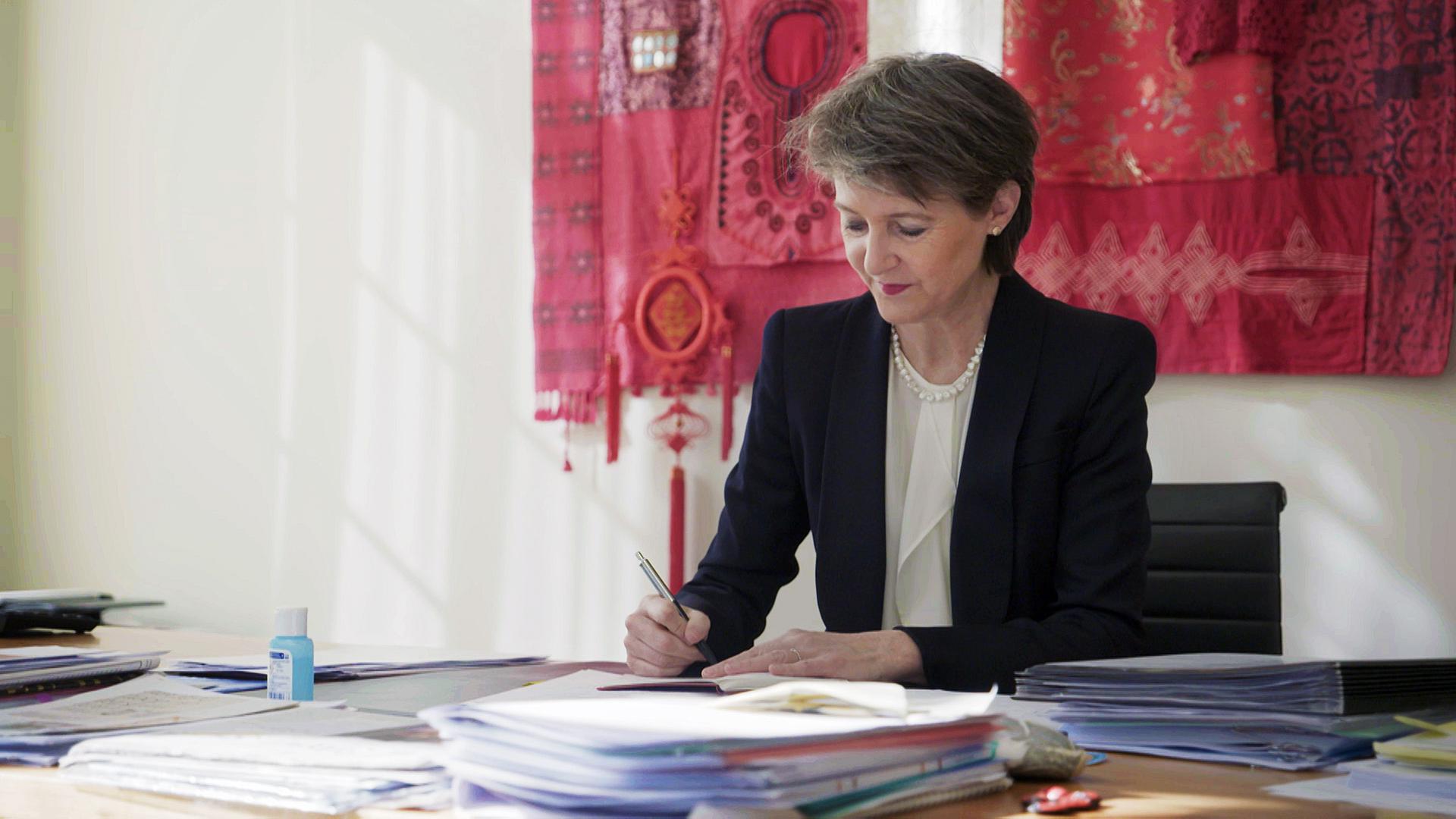 Simonetta Sommaruga arbeitet an einem Schreibtisch