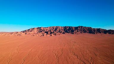 Eine Wüste mit rotem Sand.