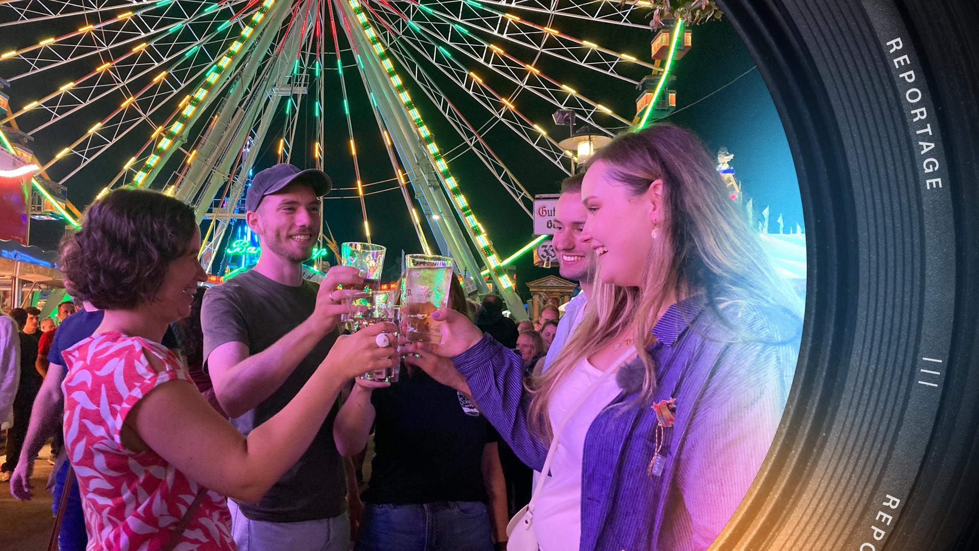 Luisa und ihre vier Freunde stehen im Kreis und stoßen mit Dubbegläsern an. Im Hintergrund stehen Menschen, das Riesenrad, Stände und ein Teil der Achterbahn.